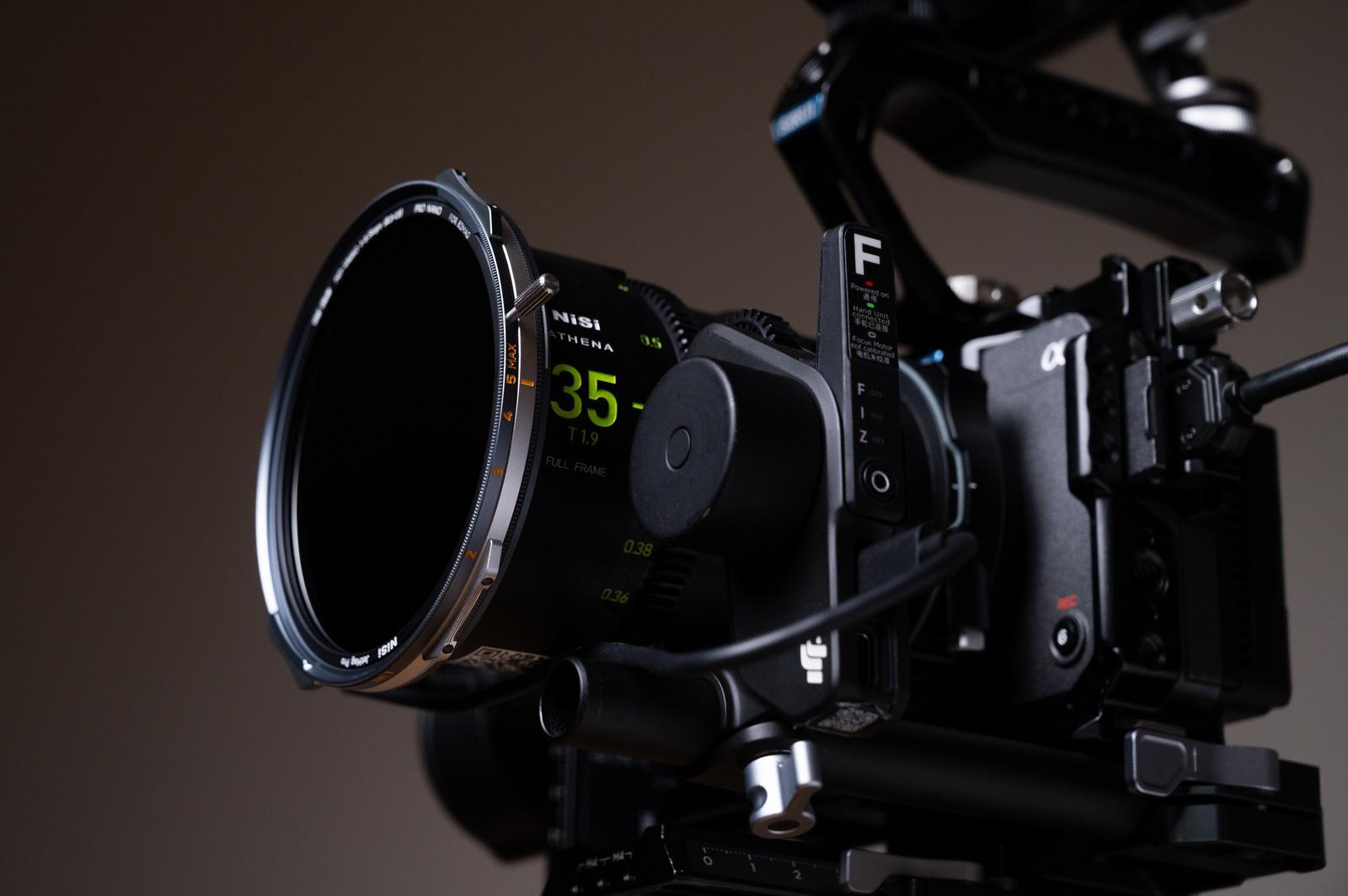 Close-up of a professional camera with lens and control panel on a dark background