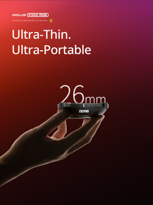 Hand holding a small device with 'Ultra-Thin. Ultra-Portable' text and '26mm' measurement on a red background.